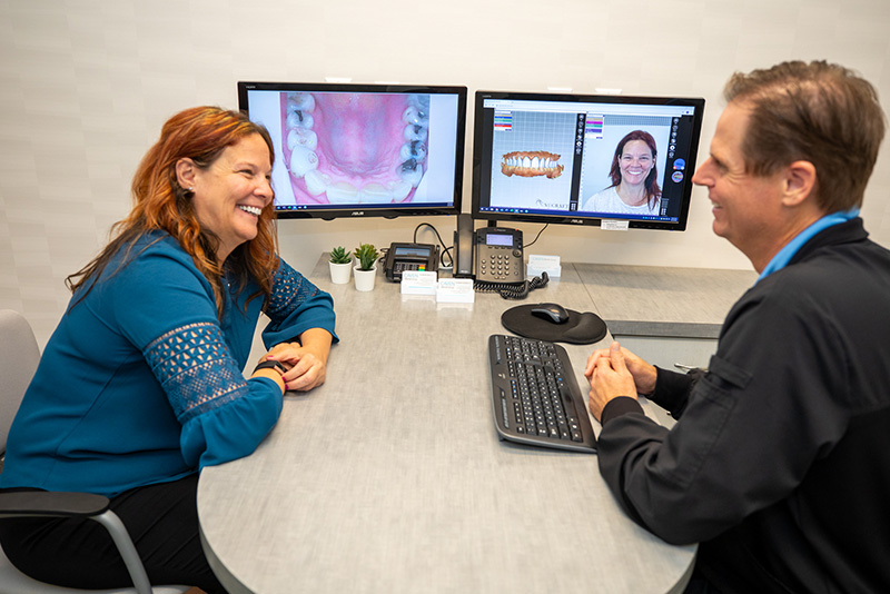 Dr Caven with a patient during a dental implants consultation